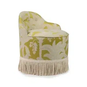 Yellow chair with palm print and tassel fringe.