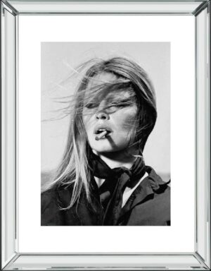 Woman smoking, black and white portrait, windswept hair.