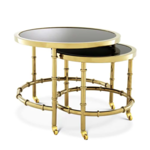 Gold nesting tables with black glass tops.