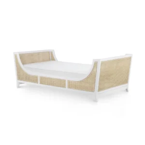 White and rattan bed with curved design.