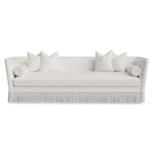 Elegant white sofa with cushions and fringe detail.