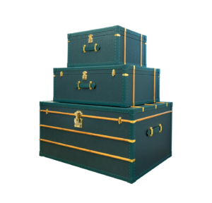 Stacked green vintage trunks with gold accents.