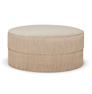 Beige fringed round ottoman furniture piece.