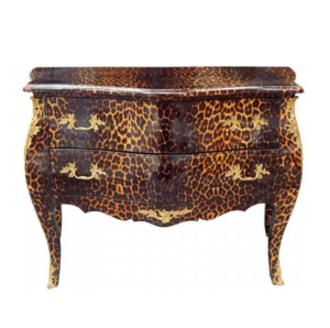 Antique dresser with leopard print and ornate handles.