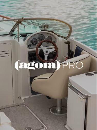 Luxury boat interior with steering wheel, ocean view.