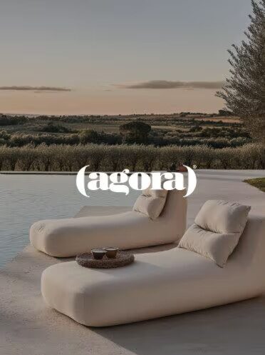 Outdoor lounge chairs with pool and landscape view.