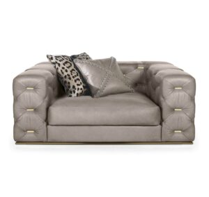 Luxurious beige armchair with decorative cushions.